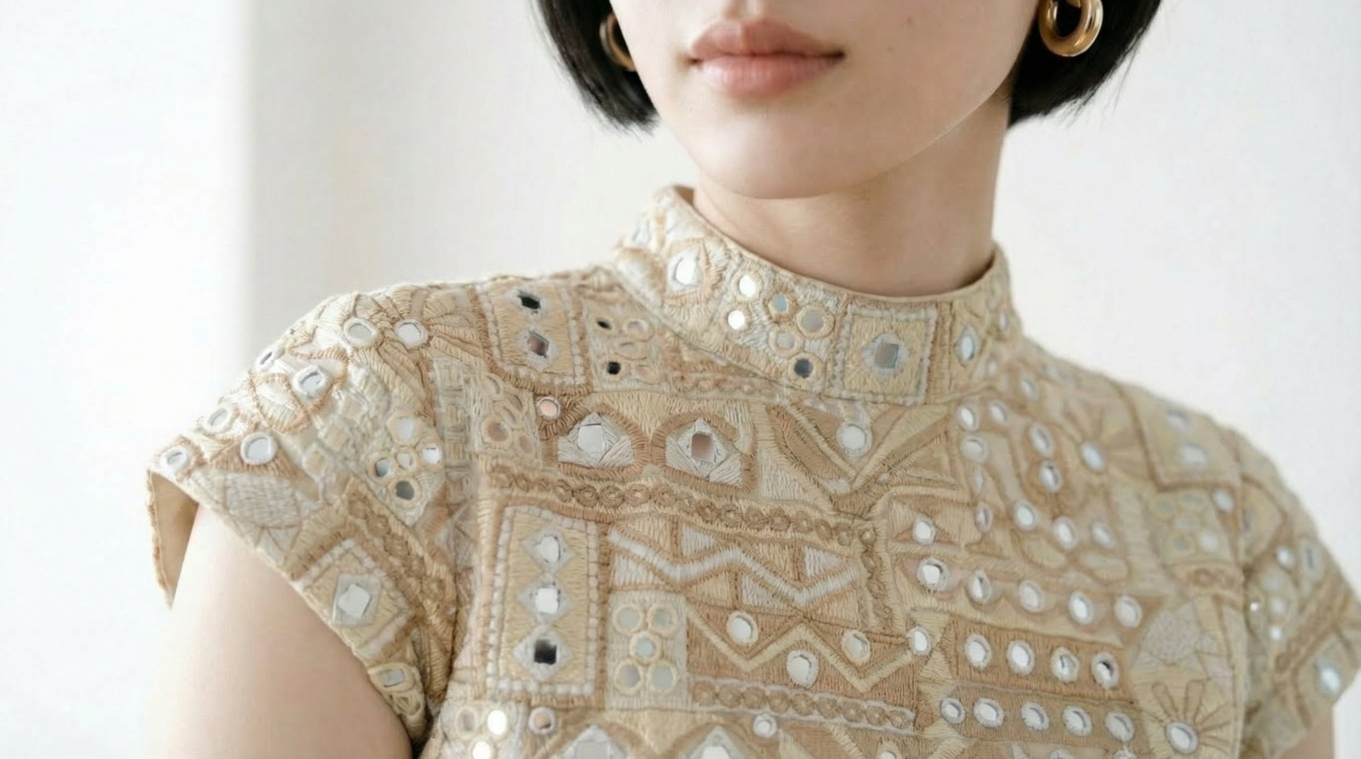 custom light gold mini dress with embroidery and faux mirror work